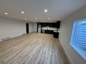 Unfurnished living room featuring recessed lighting and light wood-type flooring