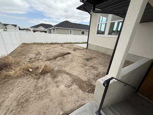 Fenced backyard with a patio area and a residential view