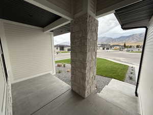 Porch with a lawn, a residential view, and a mountain view