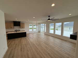 Unfurnished living room with recessed lighting, light wood-style floors, and a ceiling fan