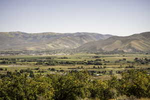 View of mountain backdrop featuring rural landscape