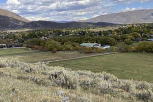 View of mountain backdrop featuring rural landscape