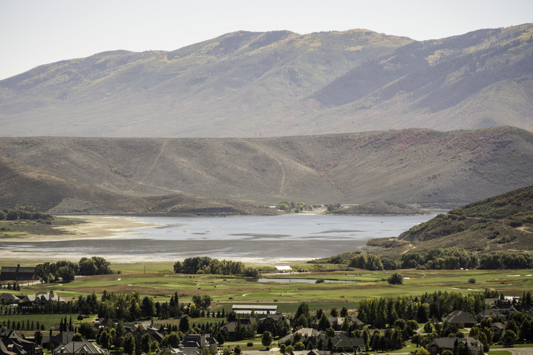 View of mountain background with a large body of water and nearby suburban area