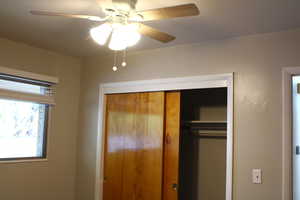 Unfurnished bedroom with a closet and ceiling fan