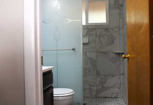 Bathroom featuring vanity and a tile shower stall