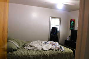 Bedroom with ceiling fan and a closet