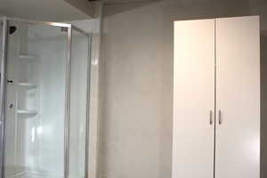 Bathroom with a stall shower and linen closet