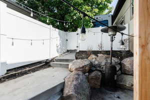 view of side yard by basement patio