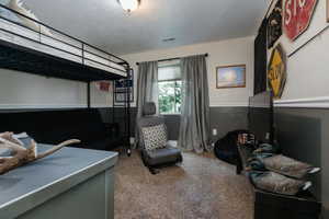 Bedroom 6  featuring a textured ceiling
