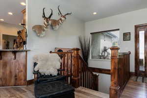 Sitting room with wood finished floors and recessed lighting