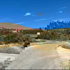 View of asphalt street featuring a mountain view