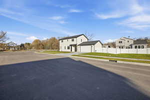View of front of property featuring a residential view and driveway