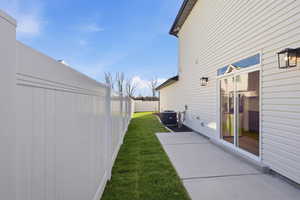Fenced backyard with a patio