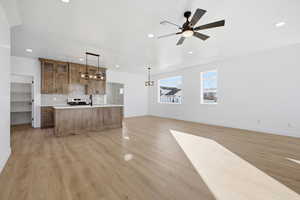 Unfurnished living room featuring light wood-type flooring, ceiling fan, and recessed lighting