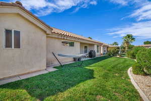 View of green lawn featuring a patio area