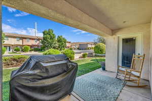 View of patio with area for grilling and a residential view