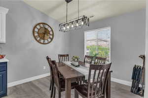 Dining space with baseboards and light wood-style floors