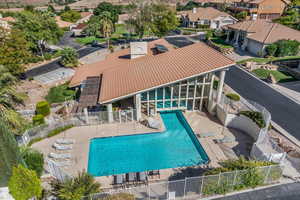 Community pool with a patio and a residential view