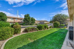 View of green lawn featuring a residential view