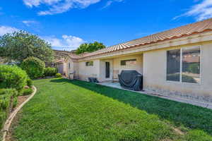 View of green lawn featuring a patio area
