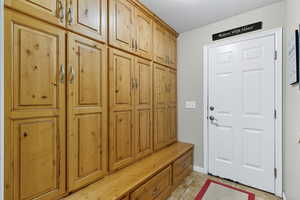 Mudroom with light tile patterned floors