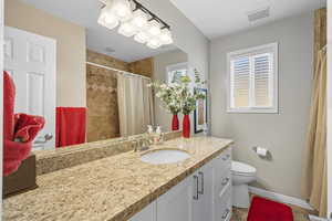 Bathroom featuring vanity and a tile shower