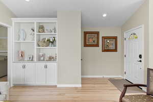 Entrance foyer with light wood-style flooring and recessed lighting