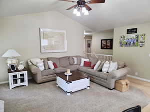 Living room with vaulted ceiling and ceiling fan