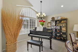Living area featuring carpet flooring, a chandelier, recessed lighting, and lofted ceiling