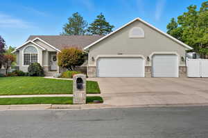 Single story home with concrete driveway, stucco siding, and an attached garage