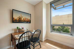 Dining area with plenty of natural light and light wood-style flooring