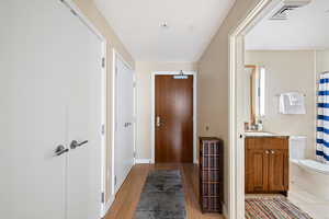 Hallway featuring light wood finished floors