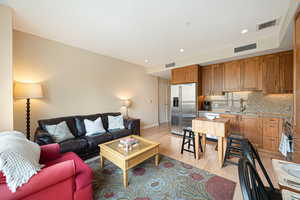 Living room featuring light wood-type flooring and recessed lighting