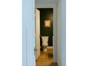 Bathroom with toilet and wood finished floors