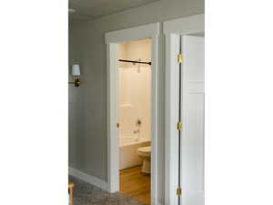 Bathroom featuring shower / bathtub combination and light wood-style floors