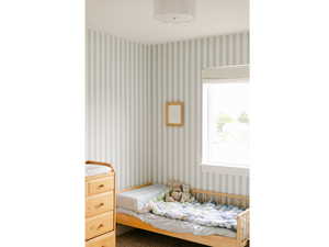 Bedroom featuring wallpapered walls