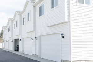 View of side of property with a garage