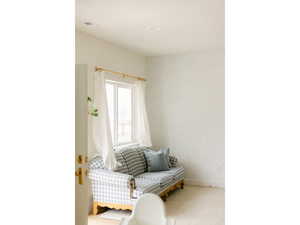 Sitting room with wallpapered walls and carpet flooring