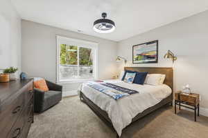 Bedroom featuring light carpet and baseboards