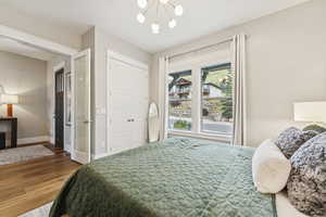Bedroom featuring a chandelier, wood finished floors, and a closet