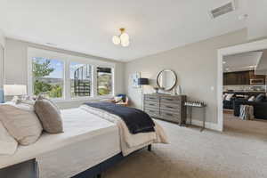 Bedroom featuring light colored carpet and baseboards