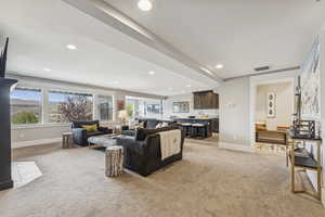 Living room with light carpet and recessed lighting