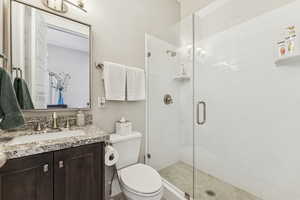 Full bathroom featuring a shower stall and vanity