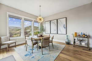 Dining area with a chandelier and hardwood / wood-style flooring