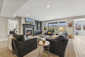 Living area with a stone fireplace and recessed lighting