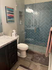 Bathroom with vanity and a stall shower