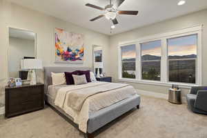 Bedroom featuring light carpet, ceiling fan, recessed lighting, and a mountain view