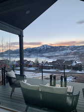 Snow covered deck with a mountain view