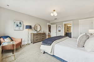Bedroom featuring carpet and ensuite bathroom