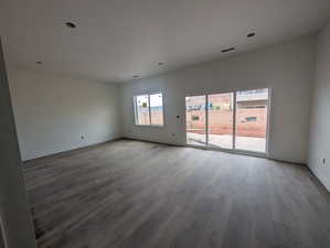 Empty room with wood finished floors and recessed lighting
